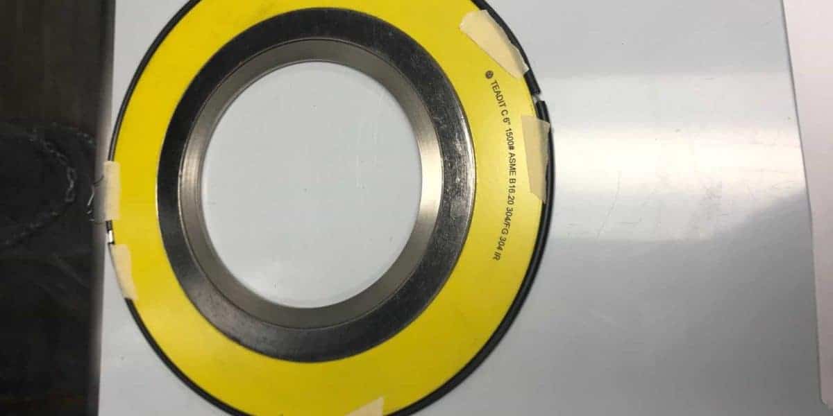 An example of a spiral wound gasket commonly seen in oil refineries, with a yellow outer ring.