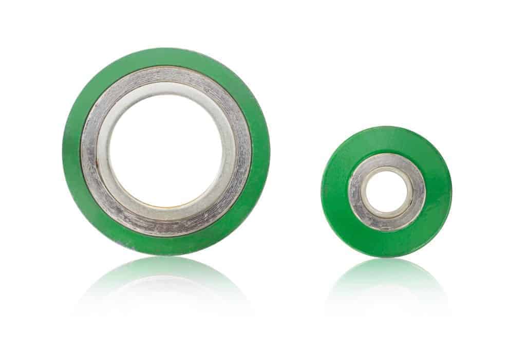 Two green spiral wound gaskets on white background.
